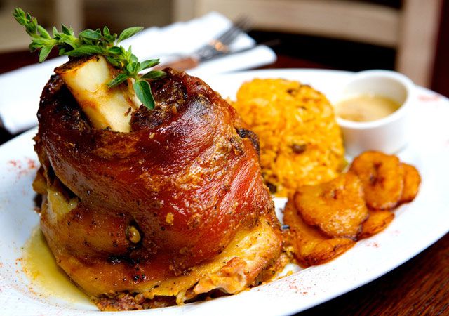 Pernil ($19), consisting of three pounds of roast pork legs with pigeon pea rice and sweet plantains.
